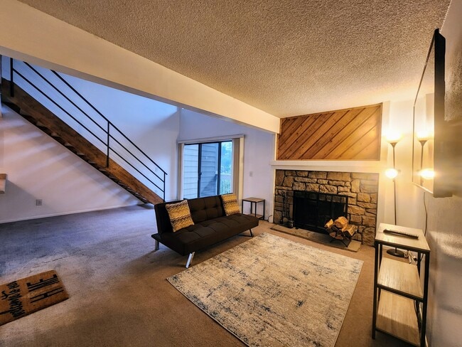 Living Room with Wood-Burning Fireplace - 4896 S Dudley St Unit 8-10