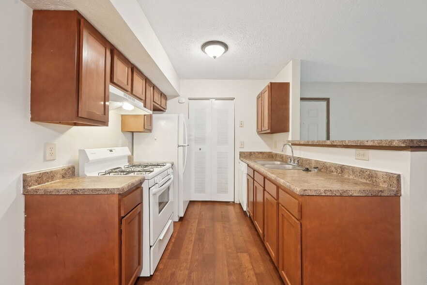 Dooley's Orchard apartment unit showing a kitchen with countertops, cabinets, stove, oven range.