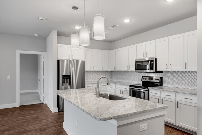 Modern kitchens with stone counter-tops and tile back-splash.