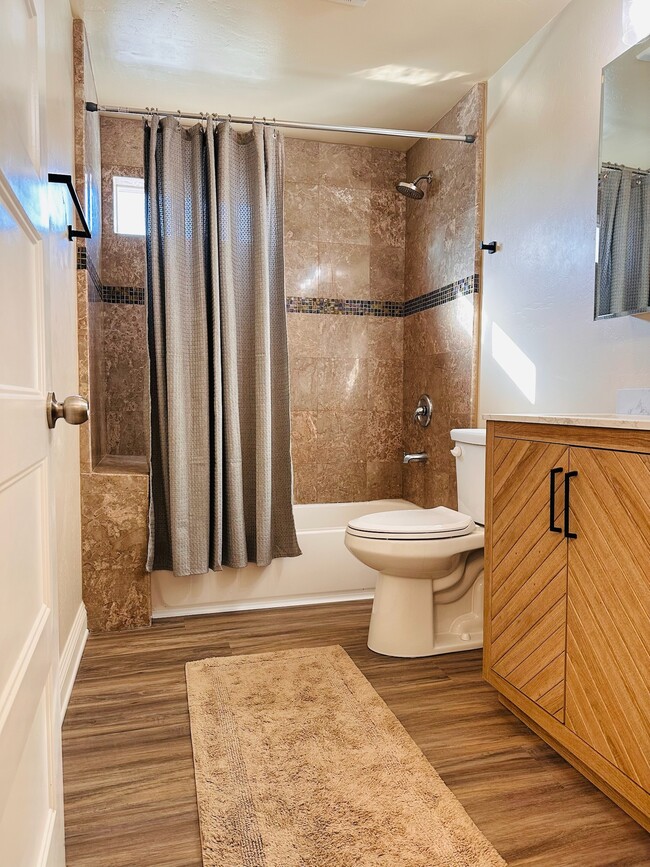 Bathroom with shower/tub and brand new vanity. - 358 22nd St Apartments Unit 2