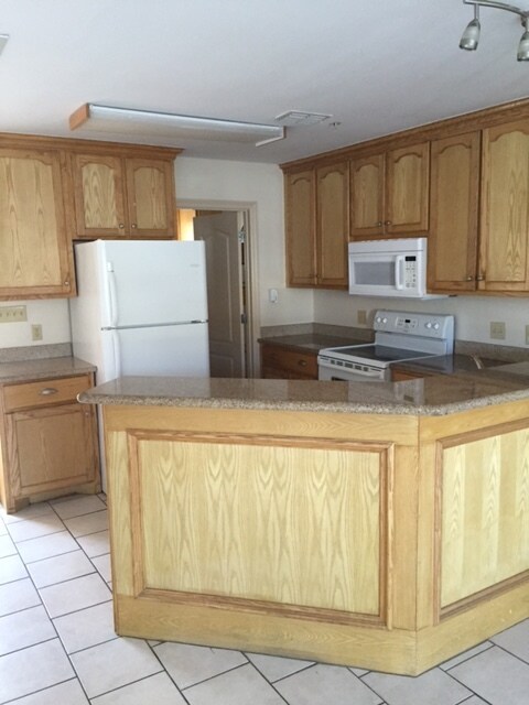 view of kitchen area with lots of cabinet space, granite countertops, and large pantry - 1503 West Fig Avenue Unidad Apt 3