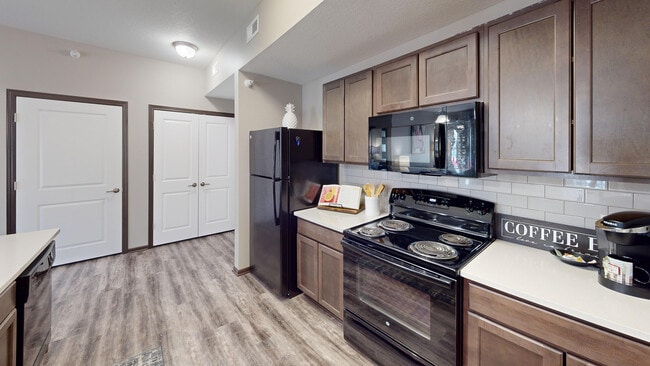 Subway tile, custom cabinetry, a dishwasher, and microwave are all kitchen features.