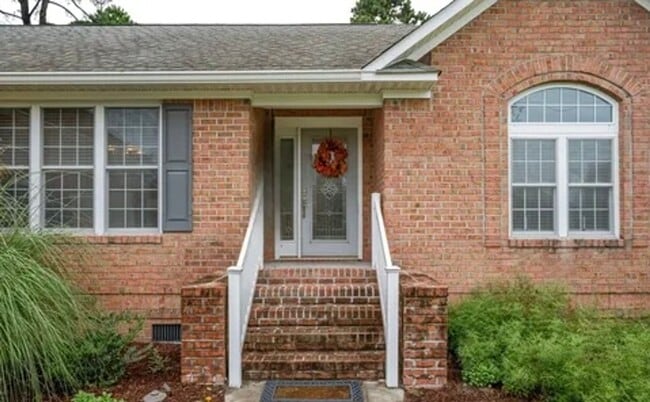 Photo - **Stately Brick Home in Fairfield Harbour | Tray Ceiling, Column, Bonus Room & Screened Porch**