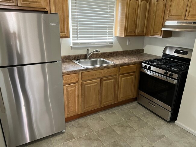 Kitchen with Stainless Appliances and Solid Oak Cabinets - Park Brook Gardens