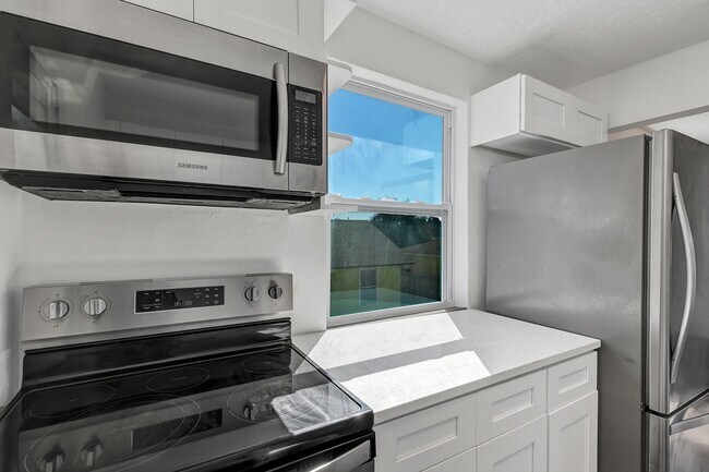 Photo - Bright & Updated 2BR Top Unit Duplex | White Kitchen & Stainless Appliances in Saint Petersburg