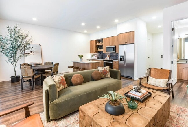 Open-concept living at Modera Higley Commons blends natural textures and sleek finishes for a space that feels both refined and relaxed.