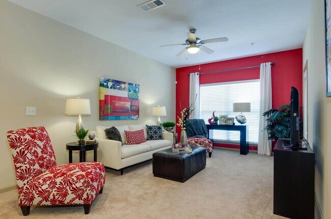 Spacious living room with large picturesque windows perfect for ample natural lighting - Ashley Auburn Pointe