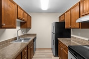 Enjoy cooking in a beautifully updated kitchen featuring sleek countertops, stainless steel appliances, and rich wood cabinetry.