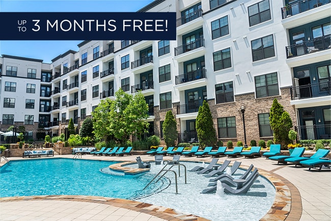 Resort-style pool with sunshelf - 2700 Charlotte Ave Apartments