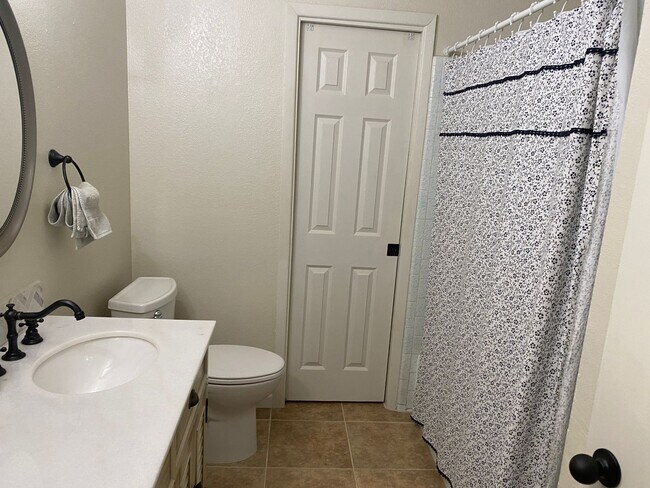 Photo - 3 bedroom home with large living room on a large corner lot with lots of room for play.