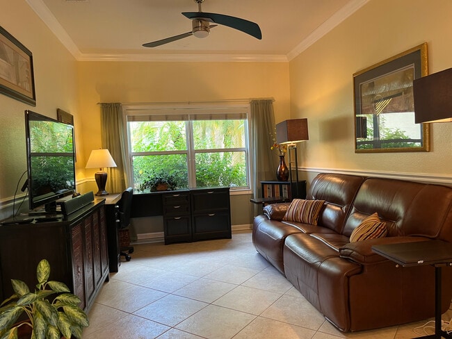 Den with leather double recliner, desk, TV - 329 NW Treeline Trce