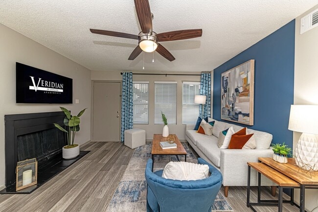 Spacious living room with hardwood-style flooring and overhead lighting - Veridian Lexington