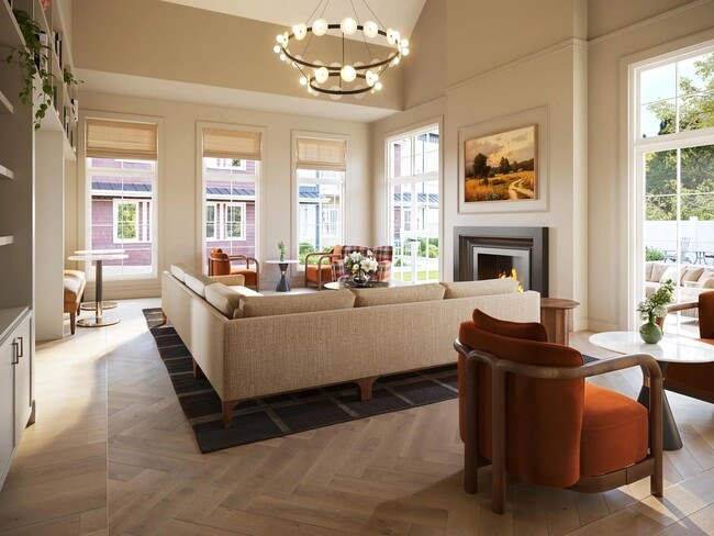 Resident lounge with soaring ceilings, curated seating, and warm lighting designed for conversation, work sessions, or quiet downtime by the fire.