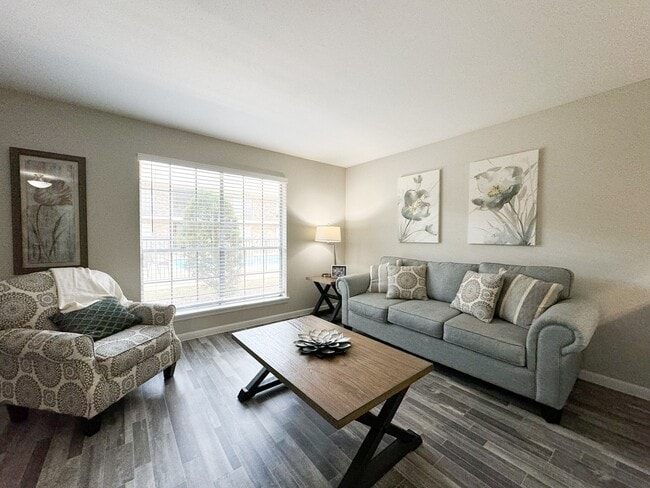 Open-plan living room with cozy seating - Memorial City Apartments