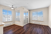 Soak in the sunlight! This spacious living area boasts large windows, a ceiling fan for comfort, and access to your own private balcony.