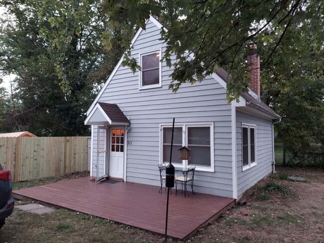 Exterior - small table and 2 chairs on deck, covered entry, exterior light - 311 Newton Aly