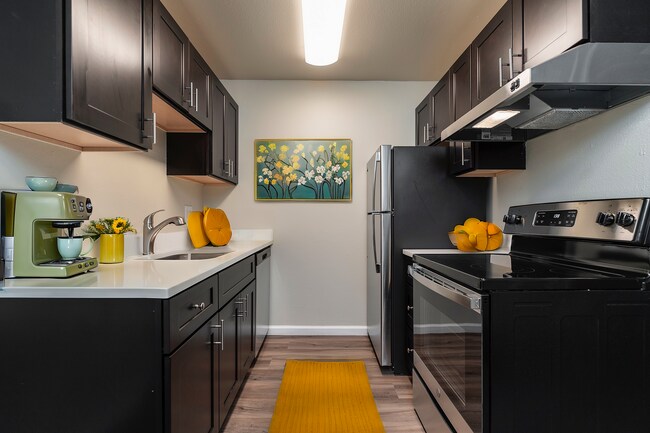 Experience a blend of style and functionality in this contemporary kitchen. - University Crossing Apartments
