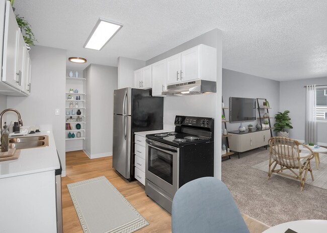 Kitchen with stainless-steel appliances and beautiful wood flooring - 2121 Multnomah Apartments