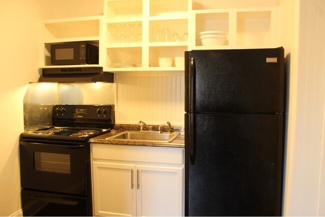 The fully stocked kitchen includes a large refrigerator with freezer. - 3813 Gallatin Pike Unit 41