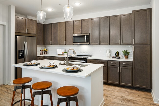 Model Kitchen with Espresso Cabinetry and Stainless Steel Appliances