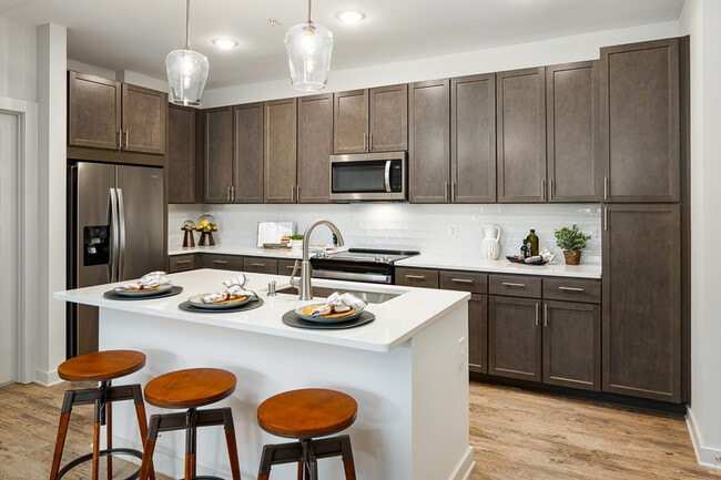 Model Kitchen with Espresso Cabinetry and Stainless Steel Appliances - Bexley Parkstone Apartments