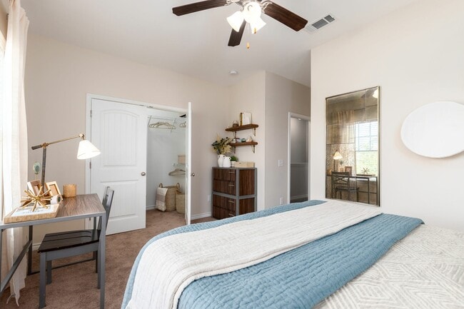 Relax in a Cozy Carpeted Bedroom with Ceiling Fan and Walk-In Closet at Seaglass Apartments