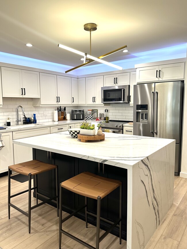 Kitchen with large island and waterfall countertop - 2318 Fox Hills Dr Unit 103