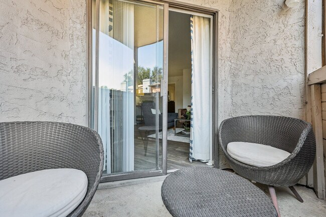 Private balcony with glass sliding door and seating