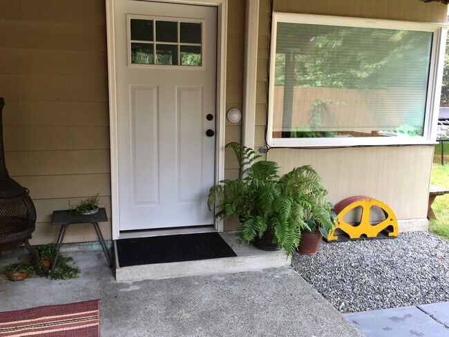Second photo of front door and patio. Private, front entrance of apartment. Picture before paint job - 3518 Northeast 94th Street Unit A