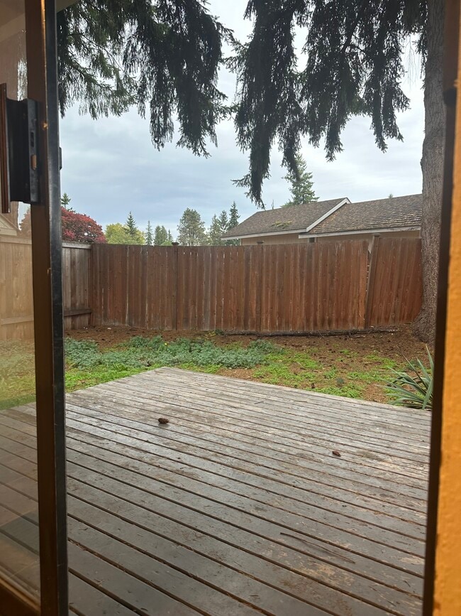 Rear of property with sliding doors to deck and fenced in back yard - 6439 Armar Rd Unit # 2