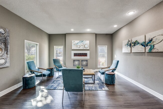 Community indoor lounge with chairs and fireplace