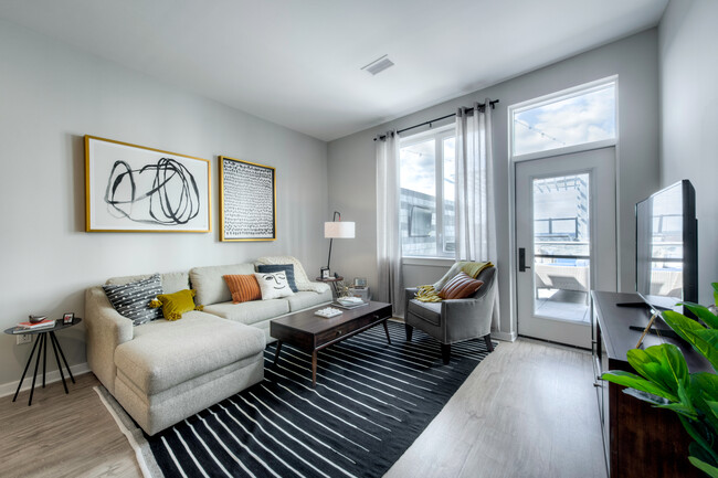 Spacious living areas with hard surface flooring balcony options - Avalon Towson Apartments