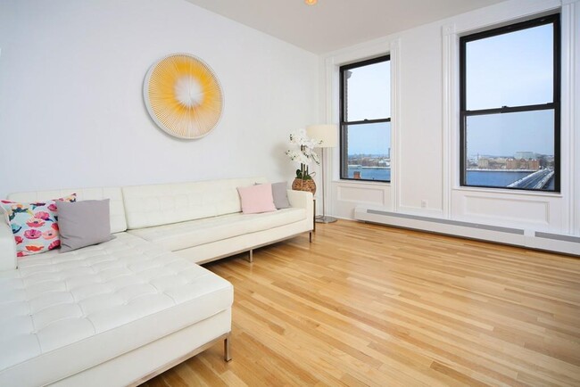 Living room with Panoramic view of the Charles River and MIT - 483 Beacon St Unit Apt 91