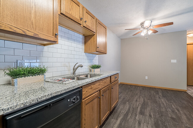 Our renovated homes have granite counters, tile backsplash, and updated flooring and cabinets. - Williamsburg Park Apartments