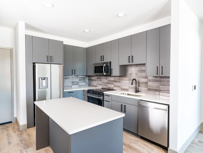 Modera Chandler features modern kitchens with multiple finish options, sleek cabinetry, and a functional island for everyday living.