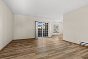 Open-concept living area with wood-style flooring and private patio access—designed for comfortable living in Tacoma, WA.