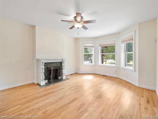 Living Room w/ Bay Windows & Fireplace! - 455 E Ferry St Unit 1