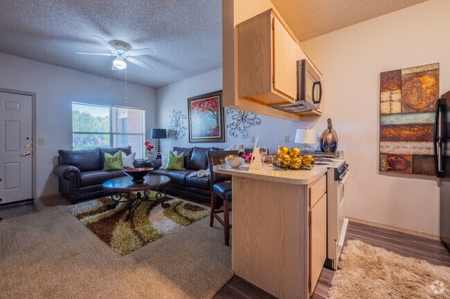 1BR 1BA - 556SF - Living room and kitchen - The Greens at Moore