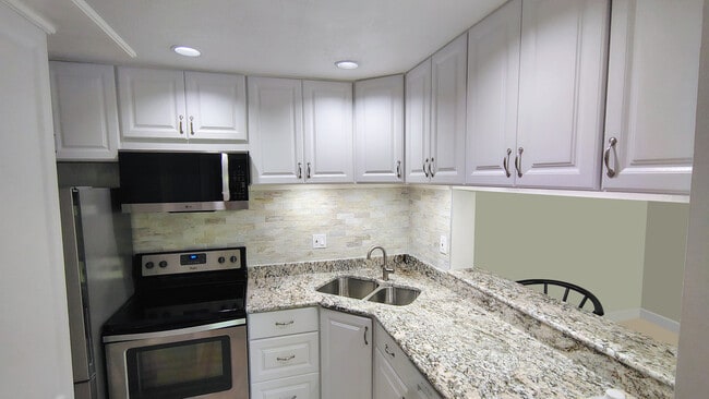 2026 remodeled kitchen with granite countertops, polished-marble backsplash, SS appliances - 1353 Pine Ridge Cir E Unit 128 E3