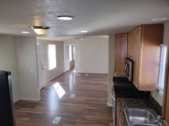 Lot16 Looking through Kitchen and Livingroom to Master Bed Entrance - 716 N Houston Lake Blvd