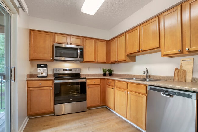 Upgraded Package I kitchen with oak cabinetry, beige laminate countertops, stainless steel appliances and hard surface flooring