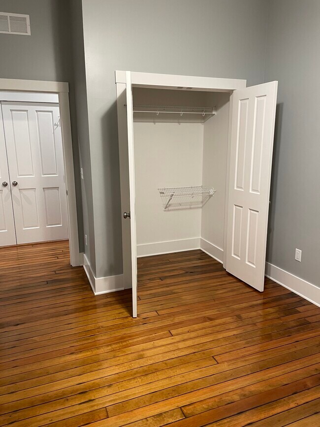 Walk-in closet of first bedroom. - 204 E Broadway Ave Unit B
