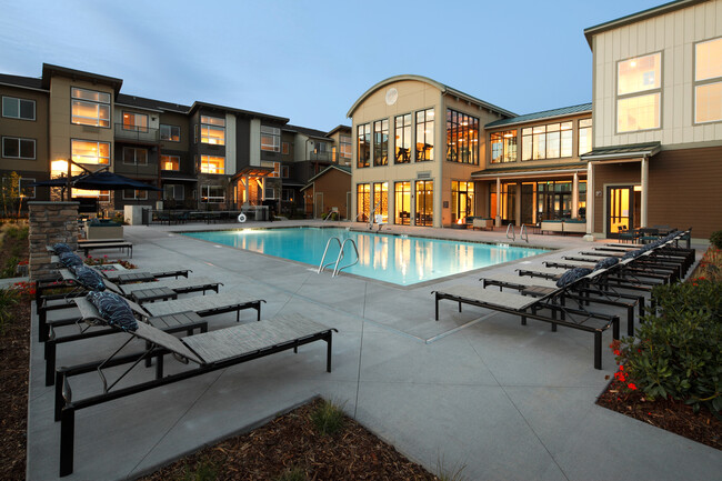 Swimming pool, sundeck with lounge seating - Avalon North Creek Apartments