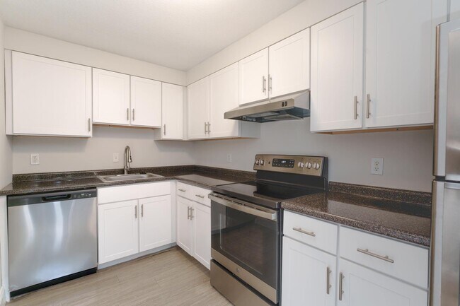 Modern kitchen style with updated white cabinetry and sleek stainless-steel appliances, creating a fresh, clean look.