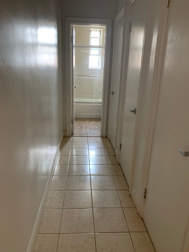 Tiled hallway with 3 closets - 286 Corbin Plz Unit 2C