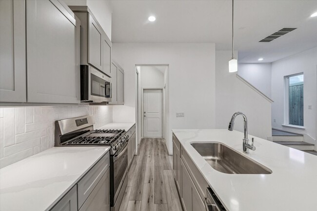 Quartz cabinets and under cabinet lighting.