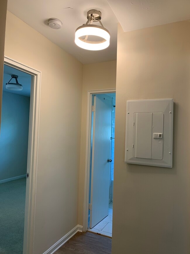 Hallway. Bedroom one is the door on the left and the Bathroom is the door on the right. - 526 Kenyon Street NW #101 Unit 101