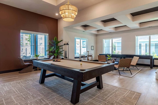 Rack 'em up in the resident game room, featuring a billiards table and comfortable seating for friendly competition any time. - Garrett Gateway