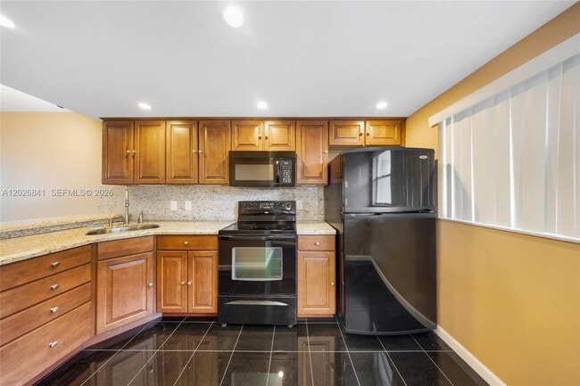 Building Photo - 6075 N Sabal Palm Blvd Unit 210