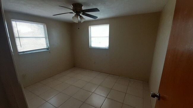 Photo - 2/1.5/1 1000 Sq. Ft. Spacious living room, Lanai, fenced in yard, and tile floors thoughout!